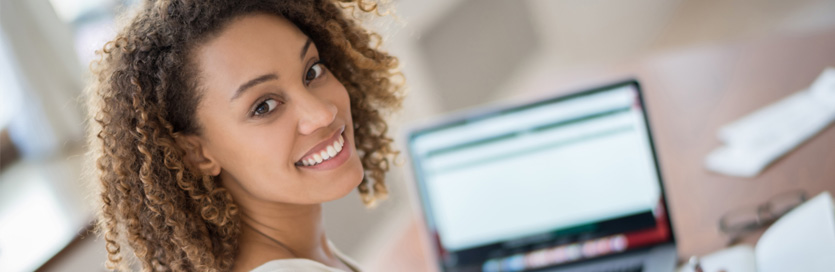 Woman on laptop smiling