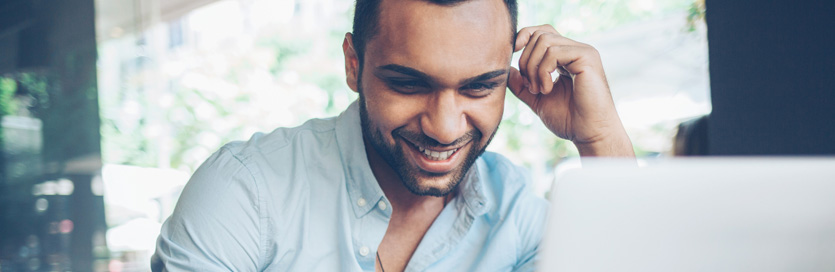 Man on laptop smiling